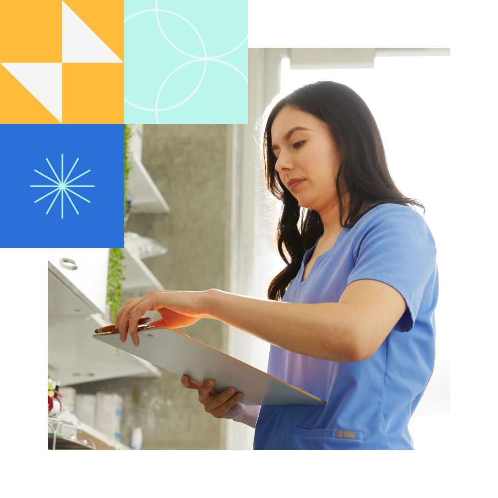 Healthcare worker reading documents on a clipboard